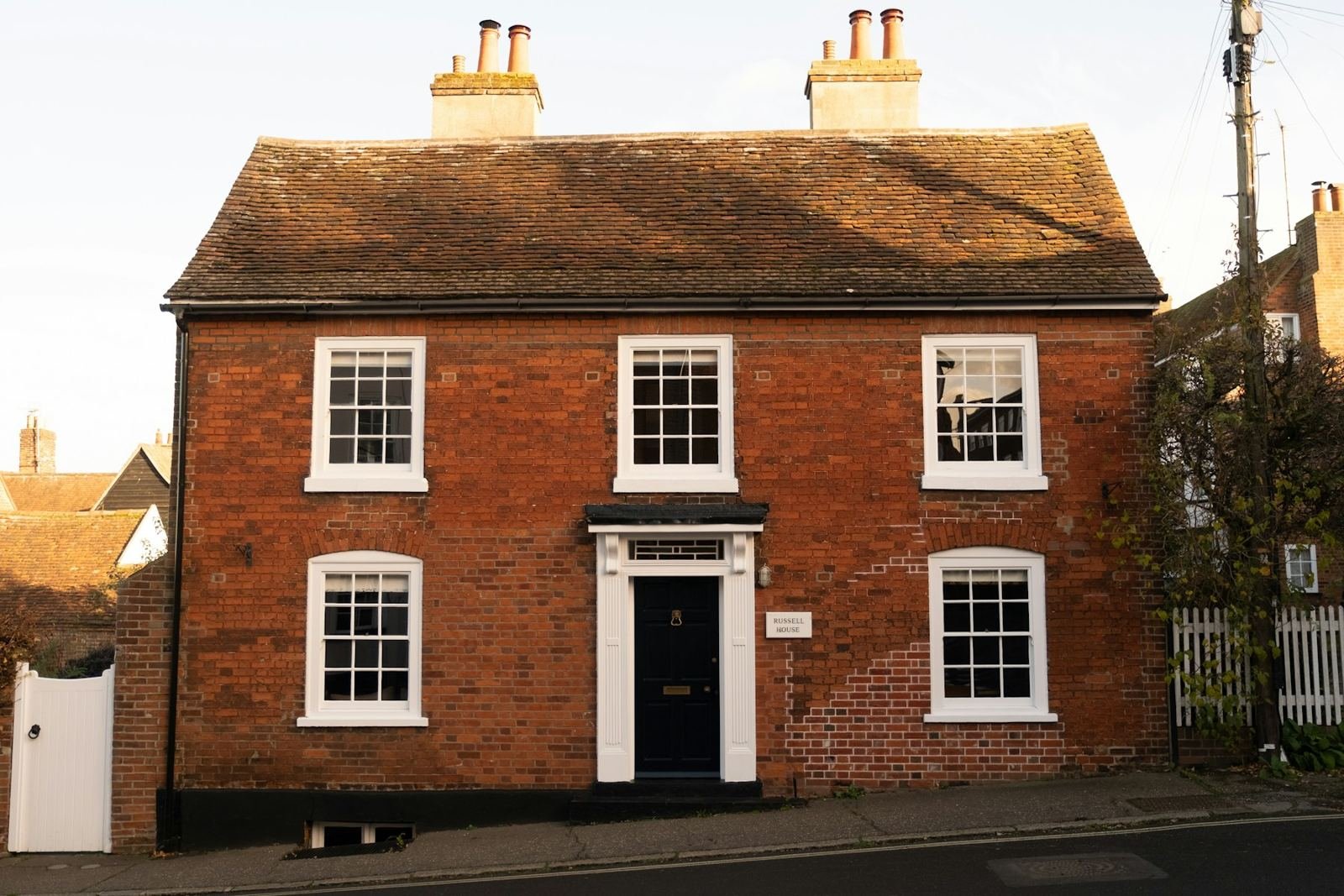 A red brick Georgian house with white sash windows